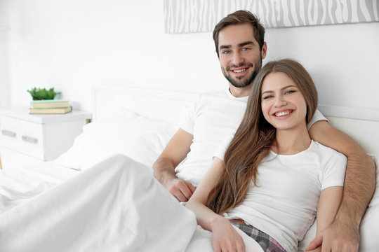 Young cute couple together in bed