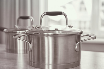 Metal saucepan on table in kitchen