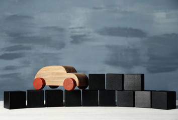 Car insurance concept. Toy and wooden cubes on colour background