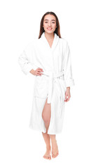 Beautiful young woman in bathrobe on white background