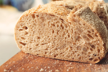 Tasty beer bread on wooden cutting board