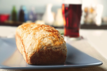 Tasty loaf of beer bread on table
