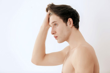 Handsome young man on light background
