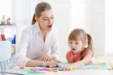 Fototapeta premium Cute little girl at speech therapist office