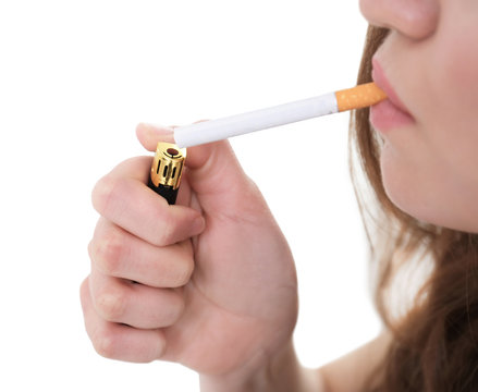 Young woman lighting cigarette, closeup