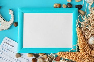 Travel concept. Composition of marine symbols and blank photo frame on blue background