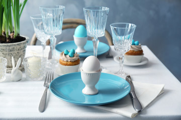 Beautiful Easter table setting with blue plate