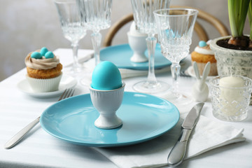 Beautiful Easter table setting with blue plate
