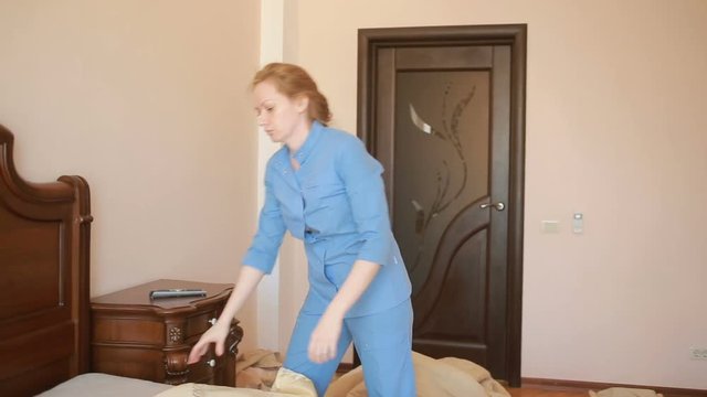 Maid doing cleaning in the bedroom