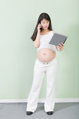 Fototapeta premium young pretty pregnant woman with tablet