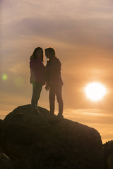 Girls playing at sunset on top of the mountain