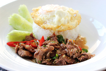 Stir fried beef with basil, chopped chili and garlic, fried egg served with steam rice
