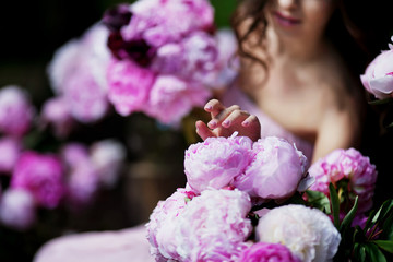 woman holding peony bouquet