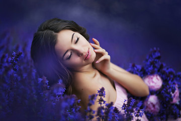 Portrait of Young beautiful pretty woman holding purple bouquet. Purple-flowers background.