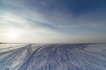 Winter landscape with a view of the setting sun