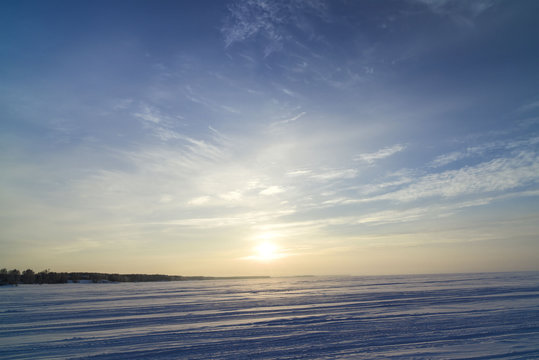 Winter landscape with a view of the setting sun