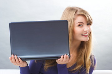 Happy smiling woman holding laptop, modern technology