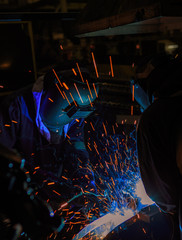 Team welder are welding in car factory 