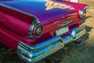 Havana, Cuba -March 14, 2016 - Back detail of a bright colored vintage classic American car in Old Havana, Cuba.