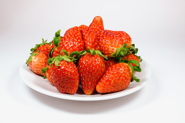 Strawberry in the white dish On a white background
