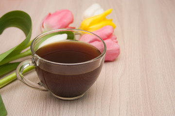 black coffee and tulips on the table, empty copyspace.