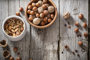 Mixed nuts on old wooden background