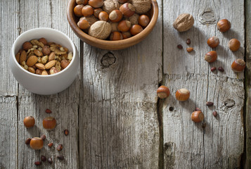 Fototapeta na wymiar Mixed nuts on old wooden background