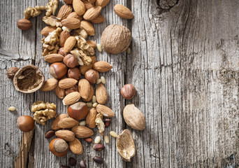 Mixed nuts on old wooden background
