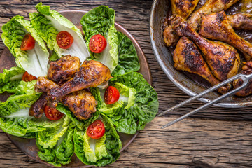 Grilled chicken legs lettuce and cherry tomatoes. Traditional cuisine. Mediterranean cuisine.