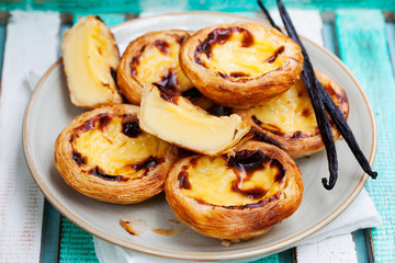 Egg tart. Portuguese dessert. Wooden background.