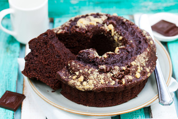 Chocolat bundt cake. Colorful wooden background.