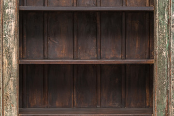 Empty shelf on wooden plank wall