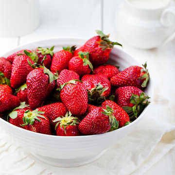 Fresh strawberry in a white bowl Rustic background