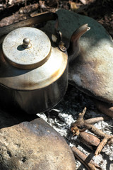 Rustic Tea Kettle set on a stone Campfire