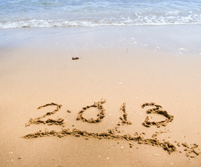 Numbers 2013 on beach - concept holiday background