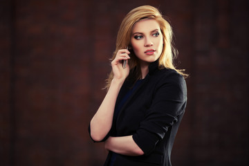 Young fashion blond business woman calling on cell phone outdoor