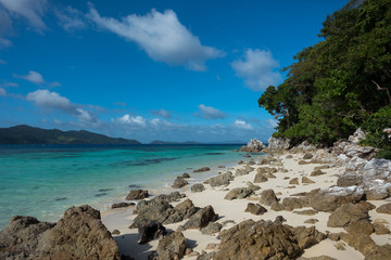 Rocky White Sand beach with turquoise sea- Port Barton, Palawan Island - Philippines