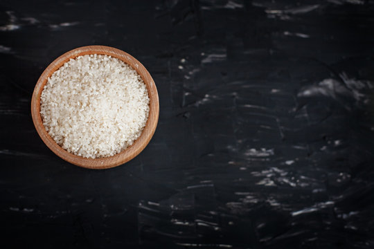 Polished rice in a wooden bowl. The concept of healthy eating and vegetarianism.