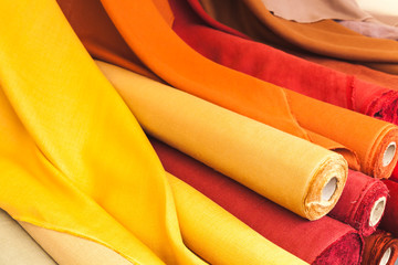 Colorful rolls of natural linen cloth