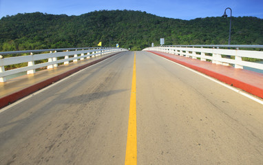 Asphalt road and mountain with blue sky