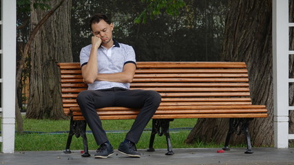 Fototapeta premium Sad Or Tired Man Alone On Bench