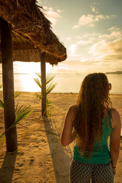 Silhouetted Woman Watching a Tropical Sunset