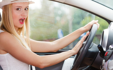 Fototapeta na wymiar Woman driving car with hand on horn button