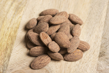 closeup of salt almonds nut on wooden background