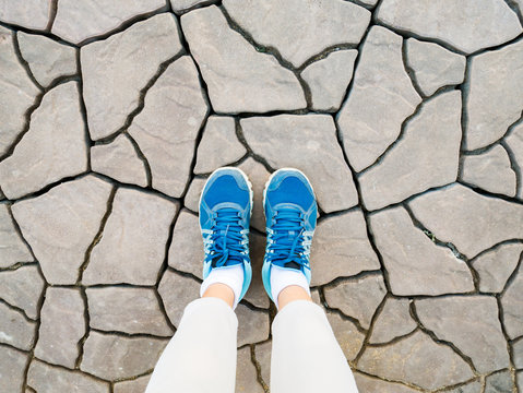 Top View Of Blue Shoes On Cracked Floor