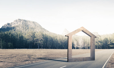Conceptual background image of concrete home sign on asphalt roa