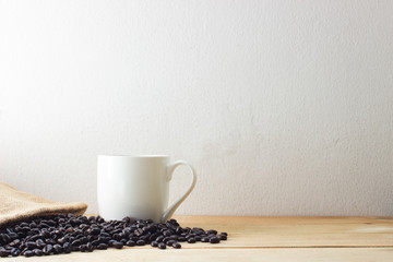 coffee bean and white cup on wood