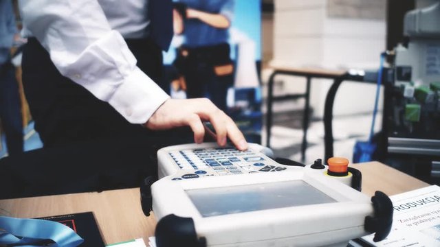 Robotics engineer uses industrial touchscreen computer. 4K shot