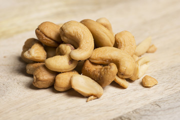 closeup of cashew nuts on wooden background