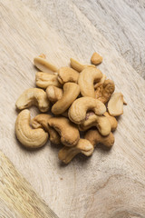 closeup of cashew nuts on wooden background